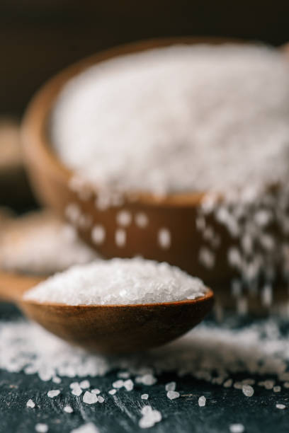 istock Pour salt into a wooden spoon, close-up 2177952467