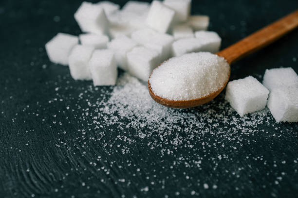 istock White crystalline sugar cubes on a wooden spoon 2177952920