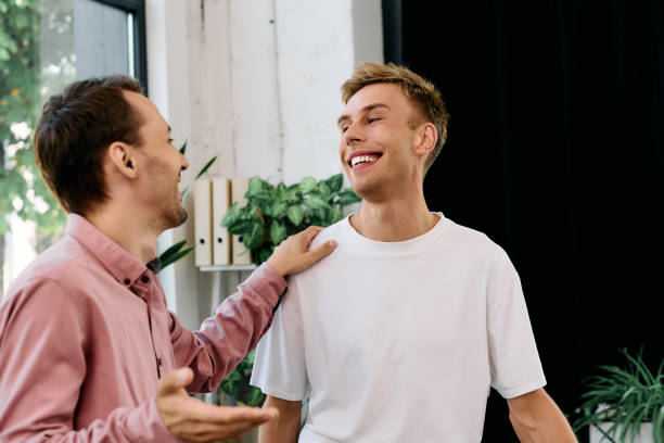 istock Two young men collaborate joyfully in a vibrant office, celebrating pride and teamwork together 2177954660