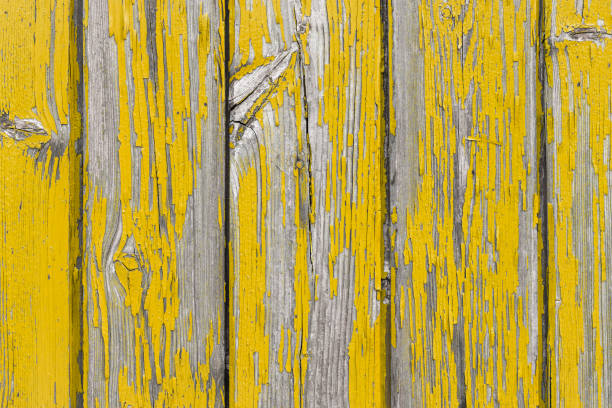 Weathered, yellow painted wood abstract background