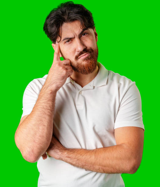 istock A man contemplates thoughtfully against a bright green background 2177956557