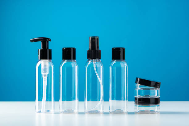 istock Clear plastic bottles with black caps arranged on a white surface against a bright blue background 2177957783