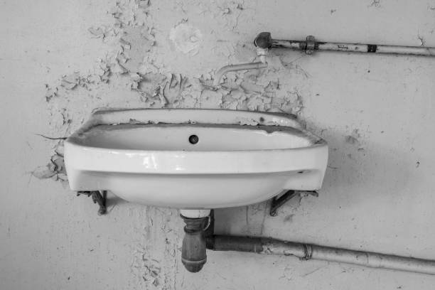 Totally renovated bathroom with shower cabin and bathtub,light cream coloured tiles on floor and wall. Point of focus mainly on tiles in forground. 