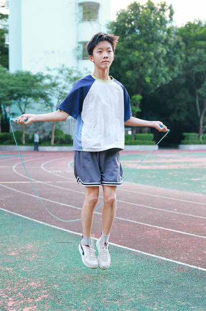 A little boy jumping rope on the playground