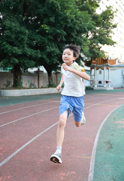 istock Boy running on the track. 2177959939