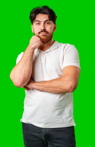 istock A man with a serious expression stands against a vibrant green background 2177962145