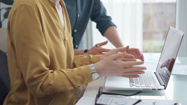 istock Team collaboration over financial reports. Business people, professionals analyzing financial charts and data on a desk while sitting near a laptop computer 2177966439