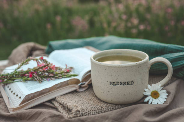 istock Cup with text BLESSED and open Bible in the garden, good morning 2177967890