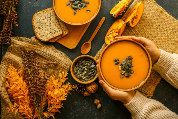 istock Pumpkin soup in hands, autumn cozy mood 2177968111