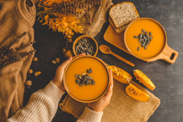 istock Pumpkin soup in hands, autumn cozy mood 2177968112
