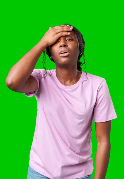 istock A woman expressing frustration while standing in front of a bright green background 2177968643