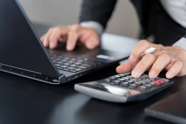 istock Close up businessman hand using calculator to calculate home finance and writing note, accounting on table. 2177968776