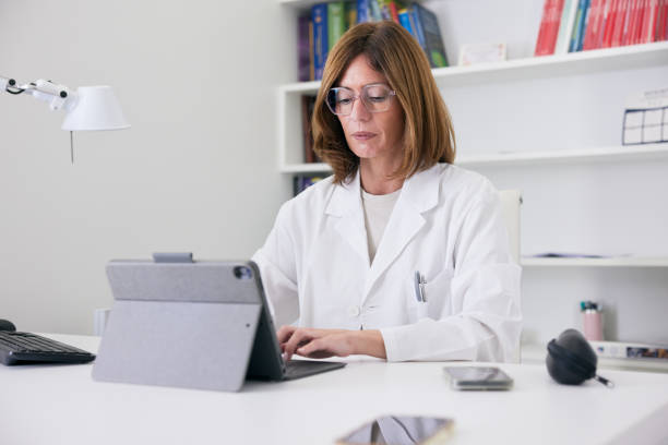 istock The doctor, seated in her office, works diligently on the computer. 2177968908