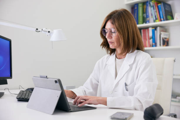 istock The female doctor is focused on her computer, working in her office. 2177968942