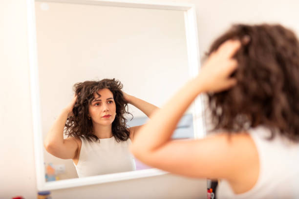 istock Woman examining her hair 2177968961