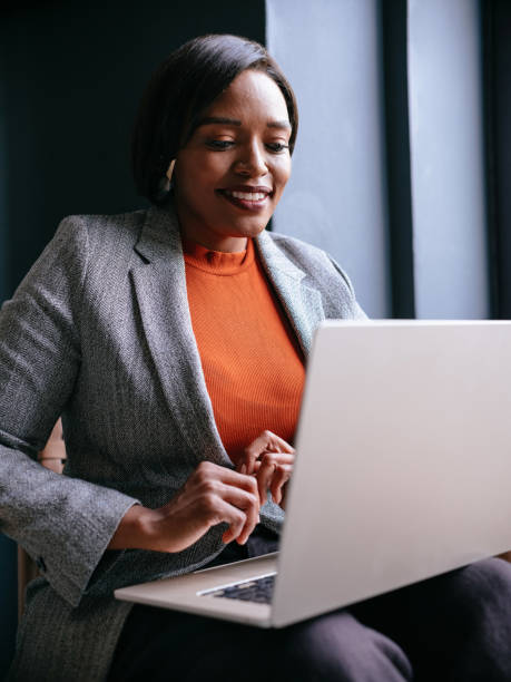 istock Professional Woman Smiling While Working on Laptop Indoors 2177969688