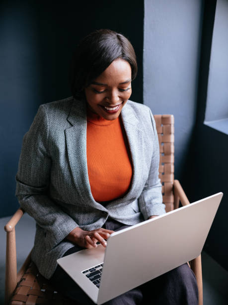 istock Confident Businesswoman Smiling While Working on Her Laptop at Office 2177969700