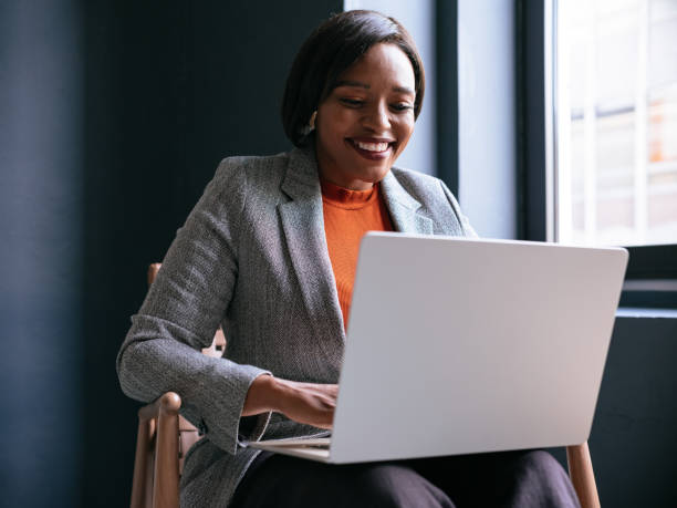 istock Professional Woman Smiling While Working on Laptop in Office 2177969715