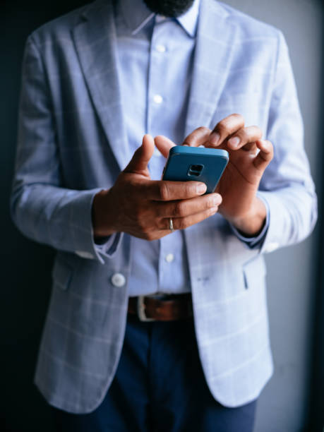 Businessman Using Smartphone in Stylish Blue Checked Suit