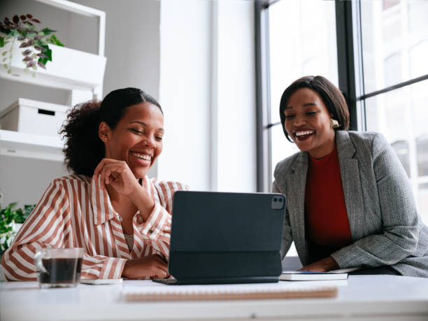 istock Two Women Collaborating On Laptop In Modern Office Setting 2177969761