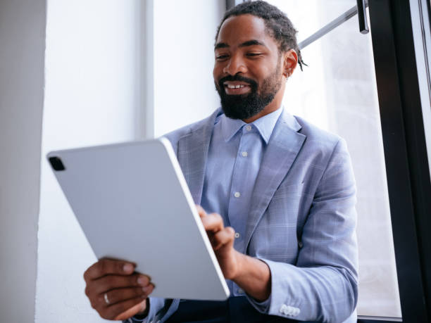 istock Business Professional Using Tablet for Online Meeting by Window 2177969786
