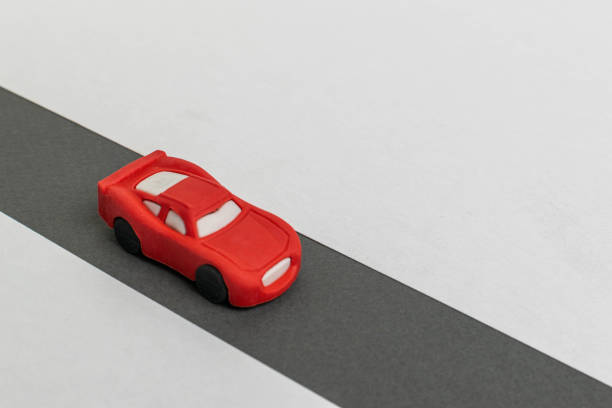 istock Minimalist Red Toy Car on Gray Road - Simplicity in Motion 2177970306