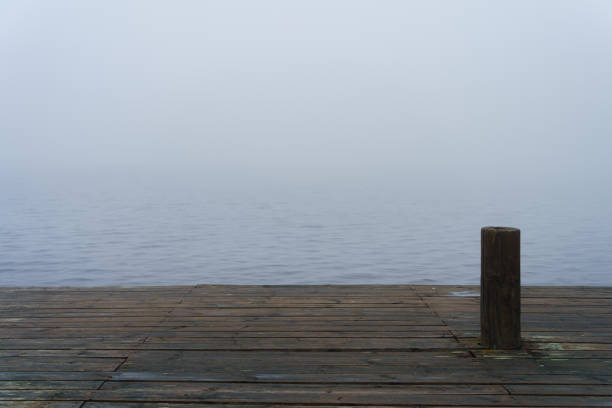 Wooden dock by a misty lake