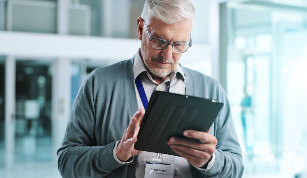 Mature man, office and tablet with reading, thinking and planning for business deal or negotiation. Male person, tech and communication with scroll on website as project management in firm or company hombre maduro, oficina y tableta con lectura, pensamiento y planificación para el trato comercial o la negociación. persona masculina, tecnología y comunicación con desplazamiento en el sitio web como gestión de proyectos en empresa o empresa
