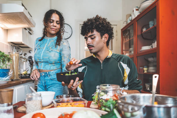 istock young woman and man preparing lunch boxes in kitchen for take away 2177972258