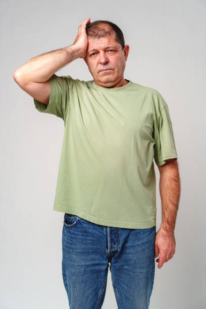 istock A middle-aged man experiencing stress while holding his head in hands against a neutral background 2177972677