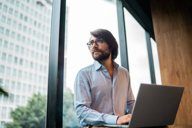 istock Young businessman contemplating and working using laptop at office 2177975046