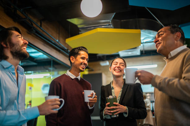 istock Coworkers talking and drinking coffee at office 2177975096