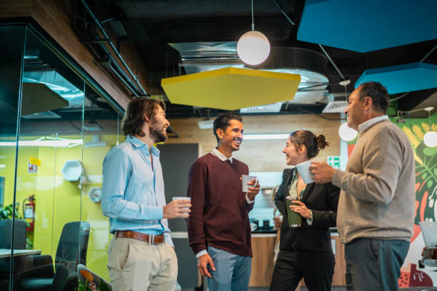 istock Coworkers talking and drinking coffee at office 2177975097