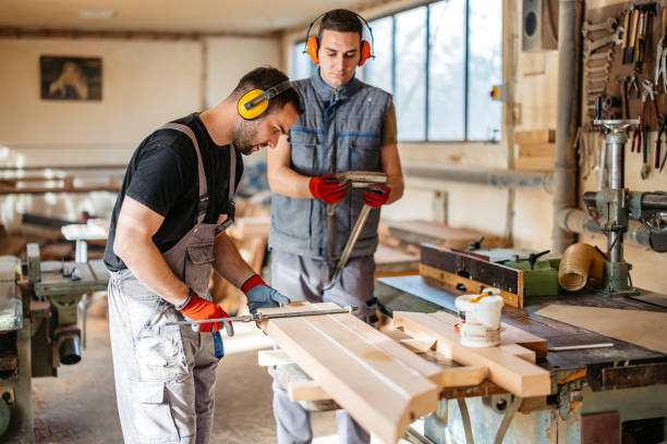 istock Two Young Male Carpenters Working With Wood In The Workshop 2177976258