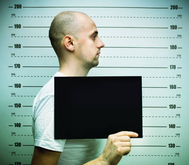 istock Young balded man posing for police mugshoot 2177976804