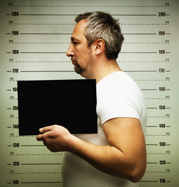 istock Man posing for police mug shot 2177977121