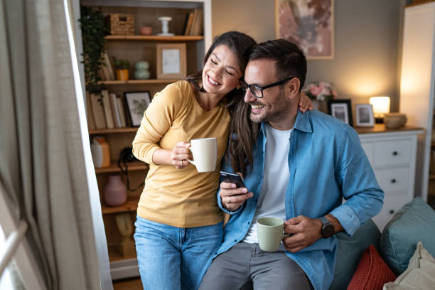 istock Young couple enjoys coffee in their home 2177977600