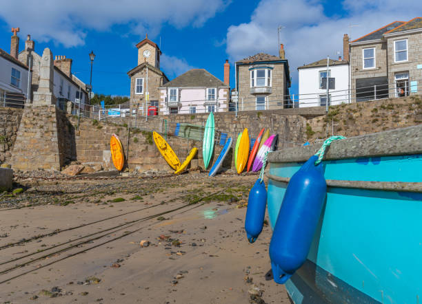 Mousehole harbour boats moored at low tide, Cornwall, England