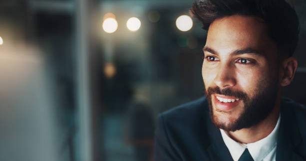 istock Night, thinking and happy man in office with computer, business plan or ideas for online project at digital agency. Research, overtime and businessman at desk checking email, web and smile at startup 2177979113
