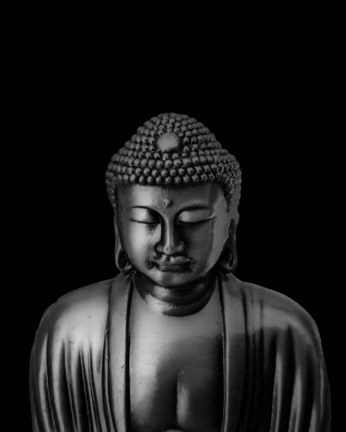 istock Buddha sculpture closeup over black background 2177979779