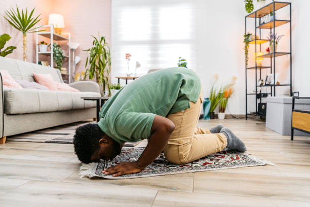 istock Young Black Muslim Man Praying At Home 2177980691