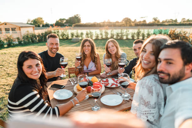 istock friends take a pic at the dinner outdoors 2177981505