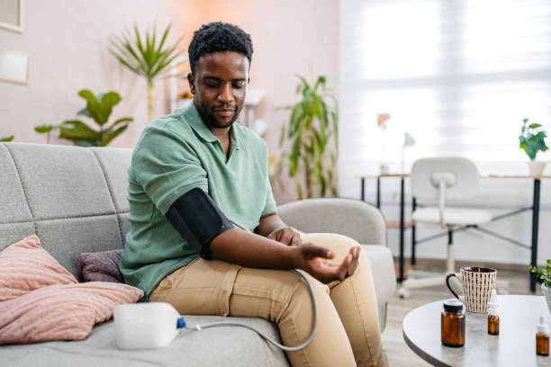 istock Young Man Measuring Blood Pressure While Sitting On The Sofa At Home 2177981506