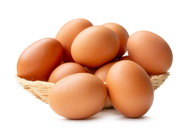 istock Group of fresh brown chicken eggs in stack in wicker basket isolated on white background with clipping path 2177983118