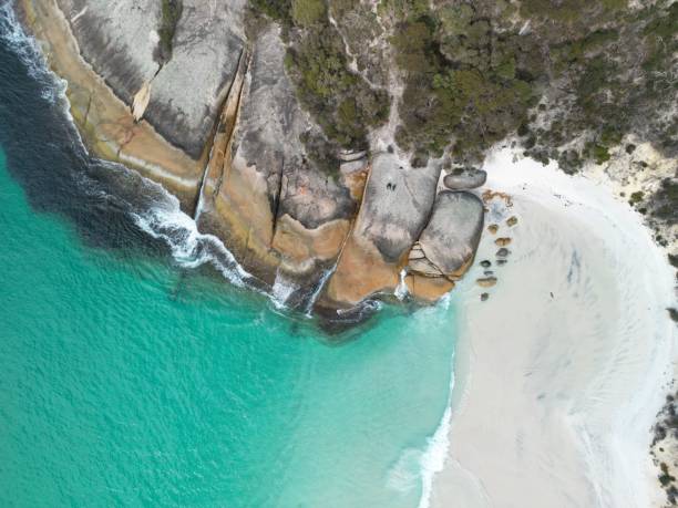istock Aerial view of a pristine beach with rocky cliffs. 2177983407