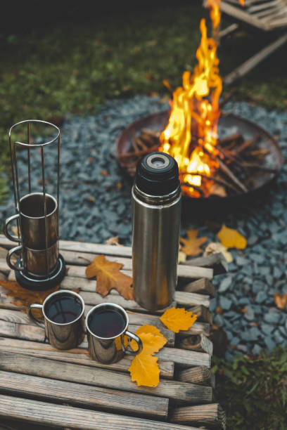 istock Themed trip. The man pours a hot drink into the thermos 2177985146