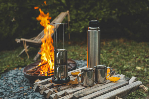 istock Themed trip. The man pours a hot drink into the thermos 2177985149