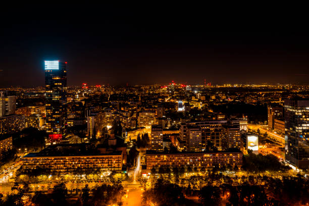 A stunning night view of Warsaw, with illuminated buildings and vibrant city lights stretching into the distance, showcasing the city’s dynamic urban landscape.