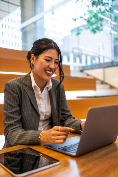 istock Businesswoman working on laptop in modern office setting 2177987955