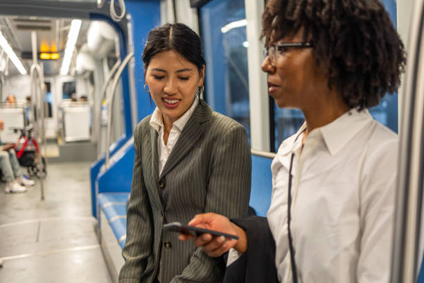 istock Professional women discussing business on a downtown Houston train 2177987987